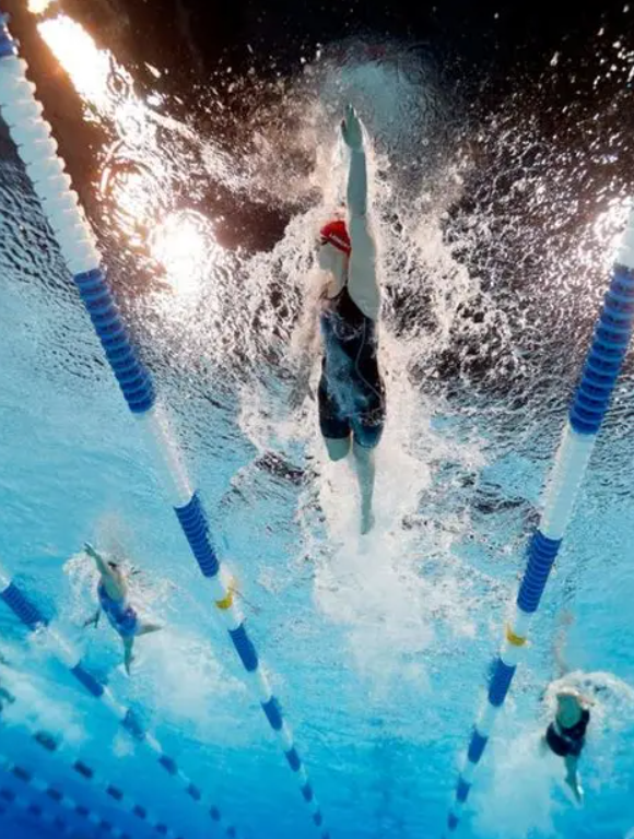 Swimmer bursting through the water